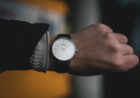 Person Wearing Round White Analog Watch at 10:09