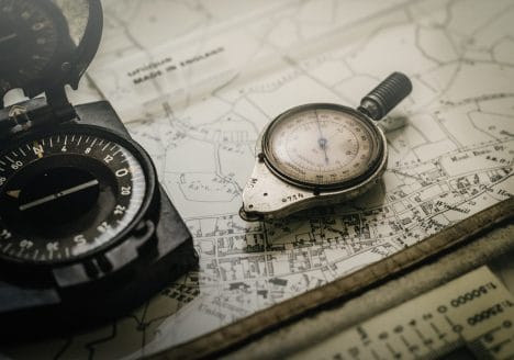 black and gray compass on top of map