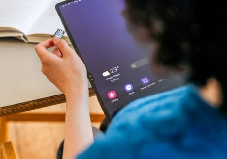A woman sitting at a table with a laptop computer