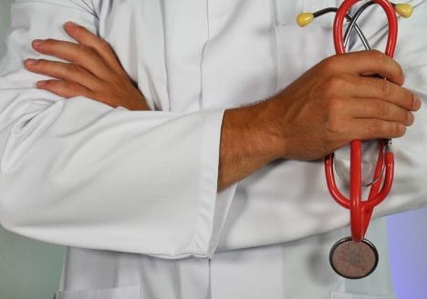 doctor holding red stethoscope
