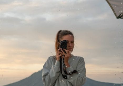 Photographer takes a photo of a mountain landscape.
